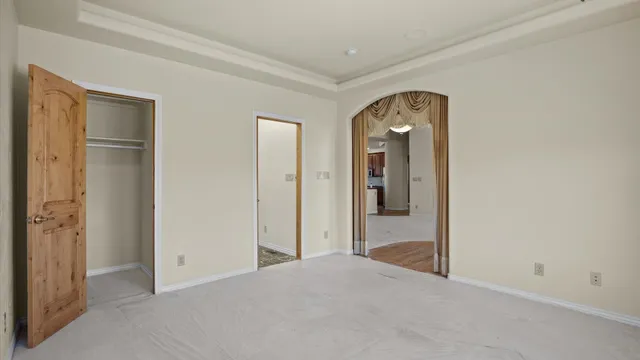 a view of a room with closet and wooden door
