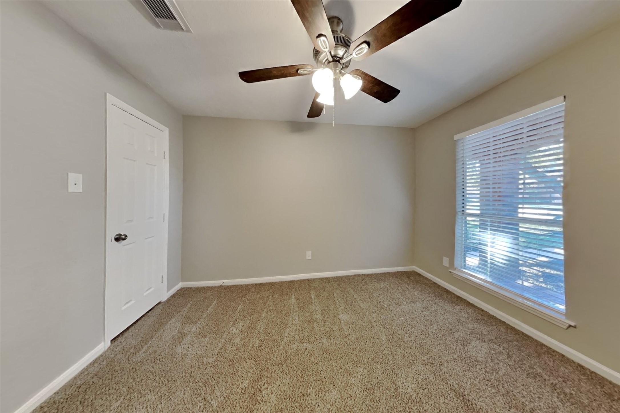 20022 Crossvine Trail Lane Cypress, TX 77433 - Photo 15 of 18 an empty room with windows and fan