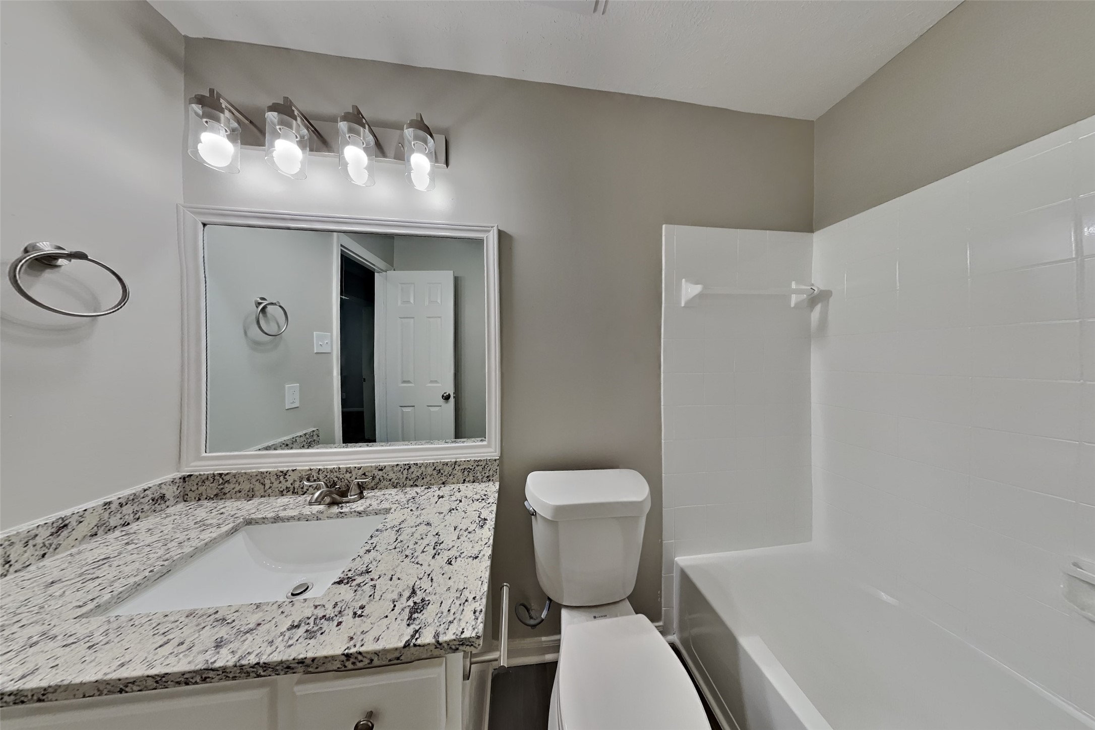 20022 Crossvine Trail Lane Cypress, TX 77433 - Photo 16 of 18 a bathroom with a granite countertop sink and a toilet
