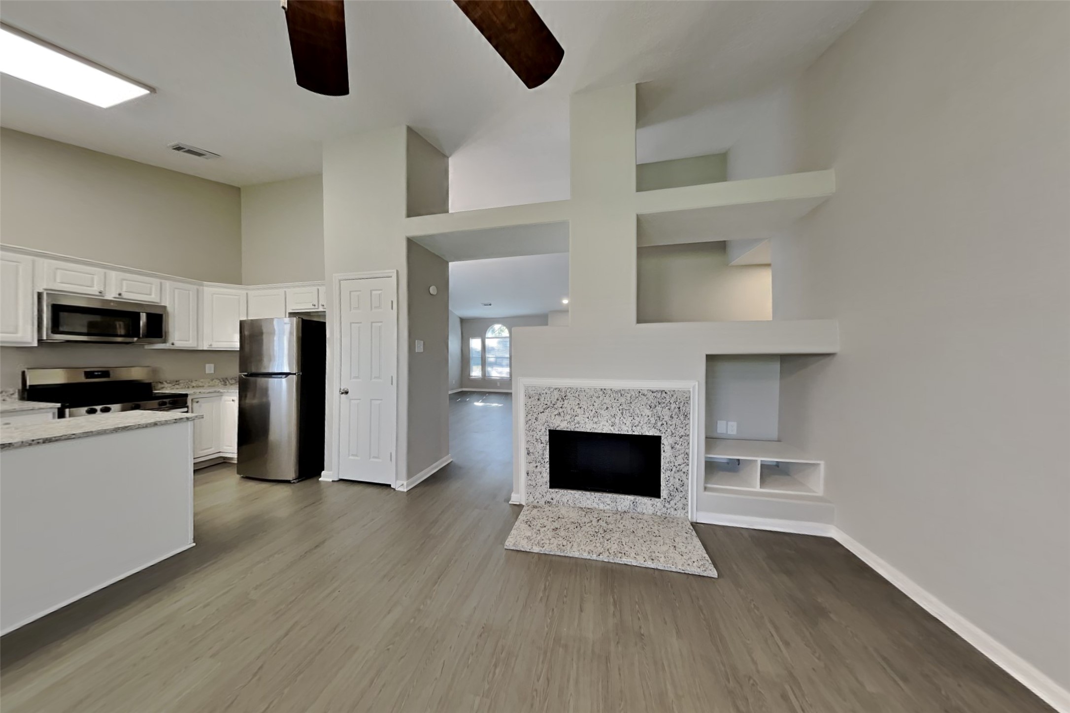 20022 Crossvine Trail Lane Cypress, TX 77433 - Photo 4 of 18 a living room with stainless steel appliances furniture a fireplace and wooden floor