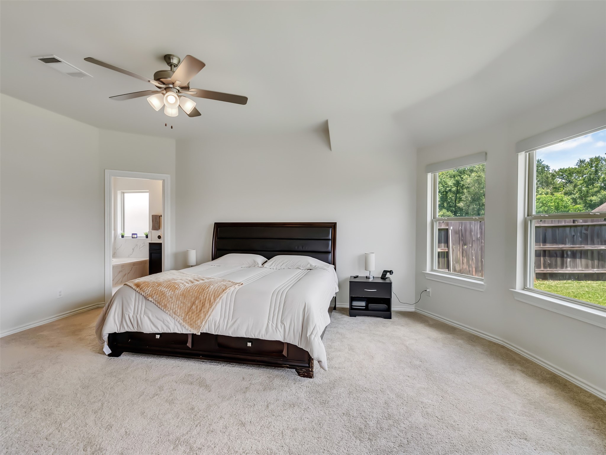 27997 Lone Hollow Lane Spring, TX 77386 - Photo 38 of 45 a bedroom with a bed and a chandelier