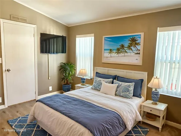 a bedroom with a bed and a painting on the wall