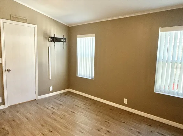 an empty room with windows and closet