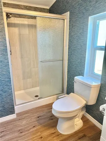 a white toilet sitting next to a bath tub