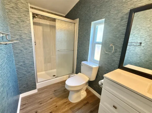 a bathroom with a toilet and a shower