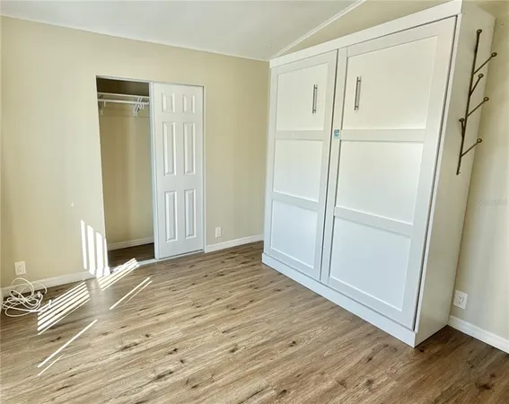 an empty room with wooden floor