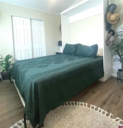 a bedroom with a bed lamp and a potted plant