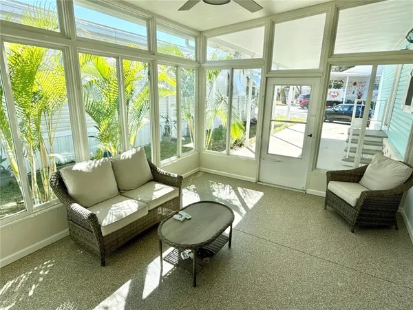 a living room with furniture and a floor to ceiling window