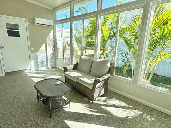 a living room with a large window and furniture