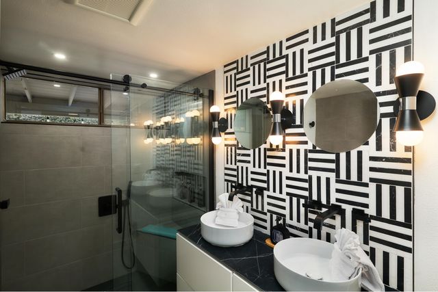 a bathroom with a sink mirror and toilet