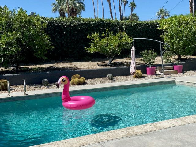 a backyard of a house with table and chairs