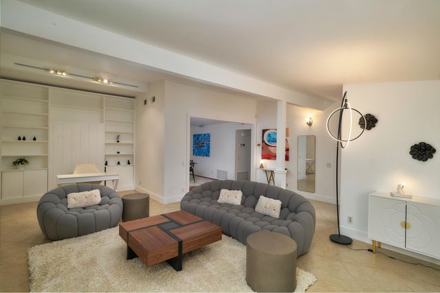 a living room with furniture and a walk in closet