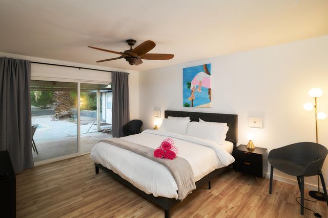 a bedroom with a bed mirror and a window