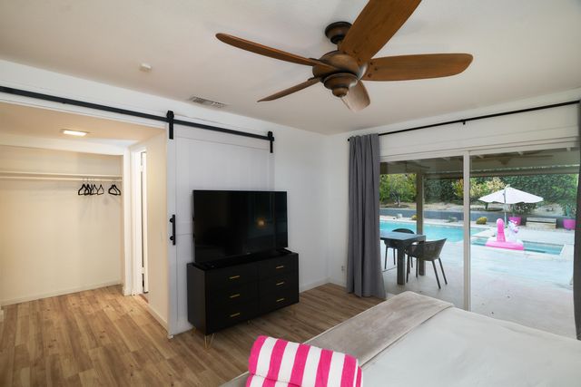 a living room with furniture and a floor to ceiling window