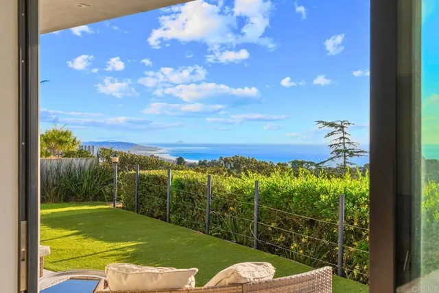 a living room with a large window and a rug
