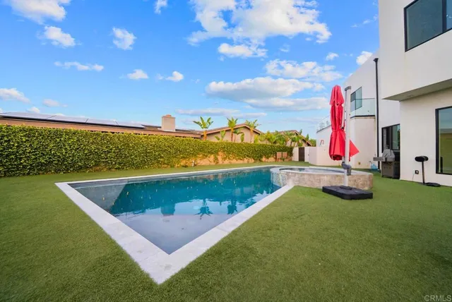 a spacious bedroom with a bed and a flat screen tv