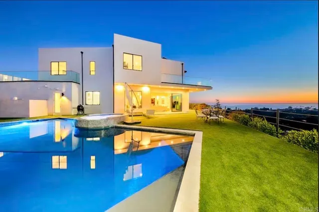 a bathroom with a granite countertop double vanity sink and a mirror