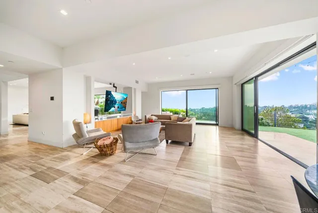 a living room with lots of furniture and a book shelf