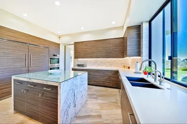 a bedroom with a large bed and a large window