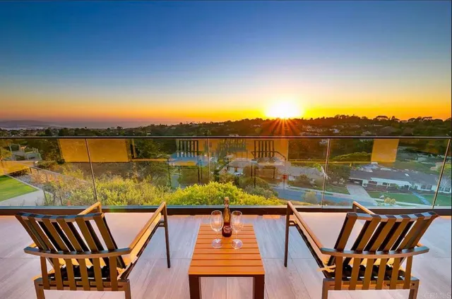 a view of a swimming pool with a table and chairs a fire pit