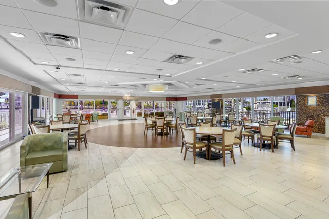 a view of a big room with lots of tables and chairs