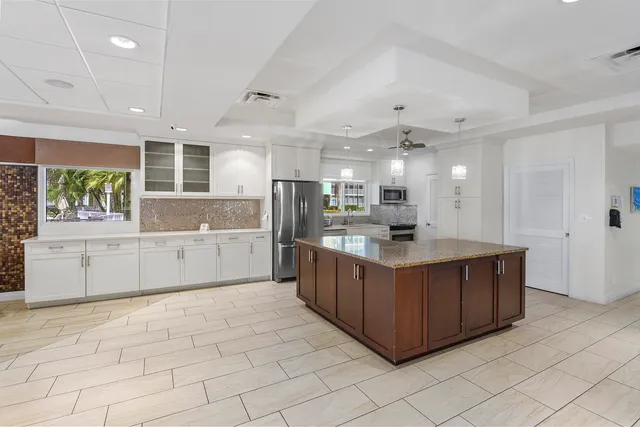 a large kitchen with stainless steel appliances lots of counter top space