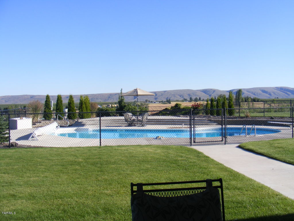 15012 Fisk Road Yakima, WA 98908 - Photo 2 of 23 a view of a park with potted plants and large trees