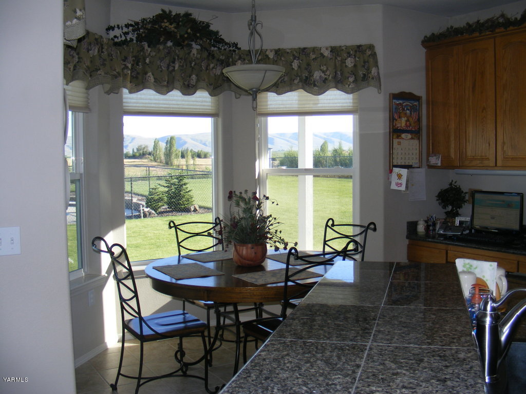 15012 Fisk Road Yakima, WA 98908 - Photo 11 of 23 a view of a dining room with furniture window and outside view