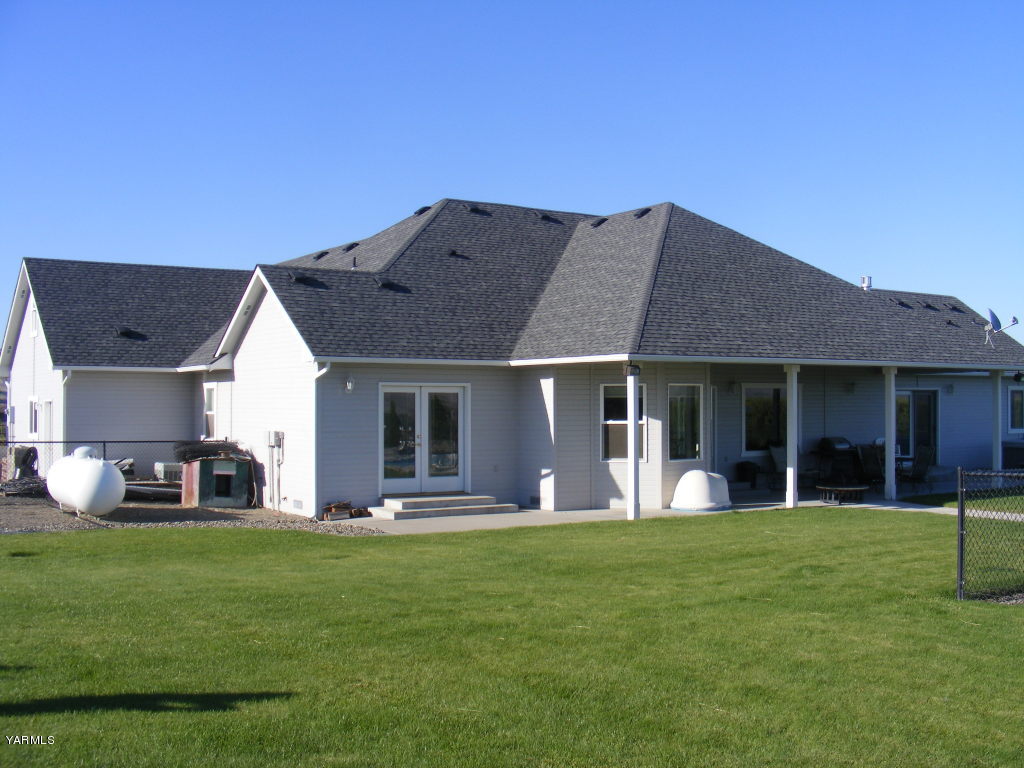 15012 Fisk Road Yakima, WA 98908 - Photo 5 of 23 a front view of a house with a garden and yard