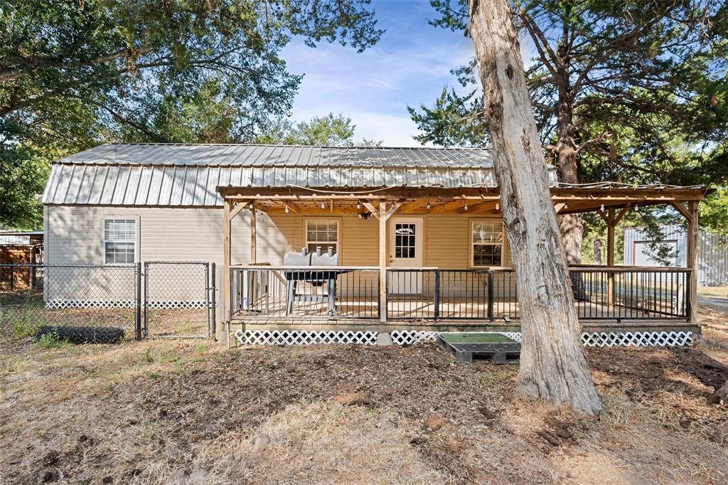 134 Maple Avenue Streetman, TX 75859 - Photo 9 of 19 Back of house with a wooden deck and a metal roof