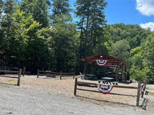 a view of a dinning table and chairs under an umbrella