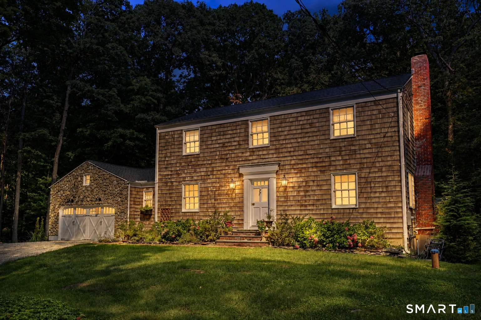 241 Mountain Road Wilton, CT 06897 - Photo 1 of 31 Twilight brings out the magic of 241 Mountain Road. Classic New England charm with a warm, welcoming glow.