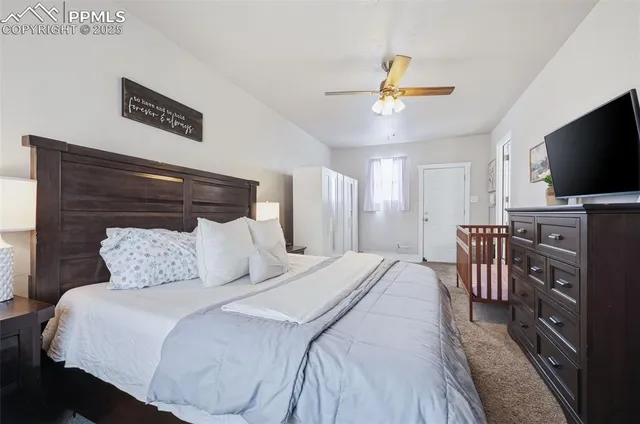 a bedroom with a bed and a flat screen tv