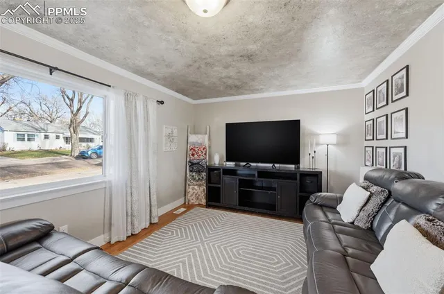 a living room with furniture and a flat screen tv