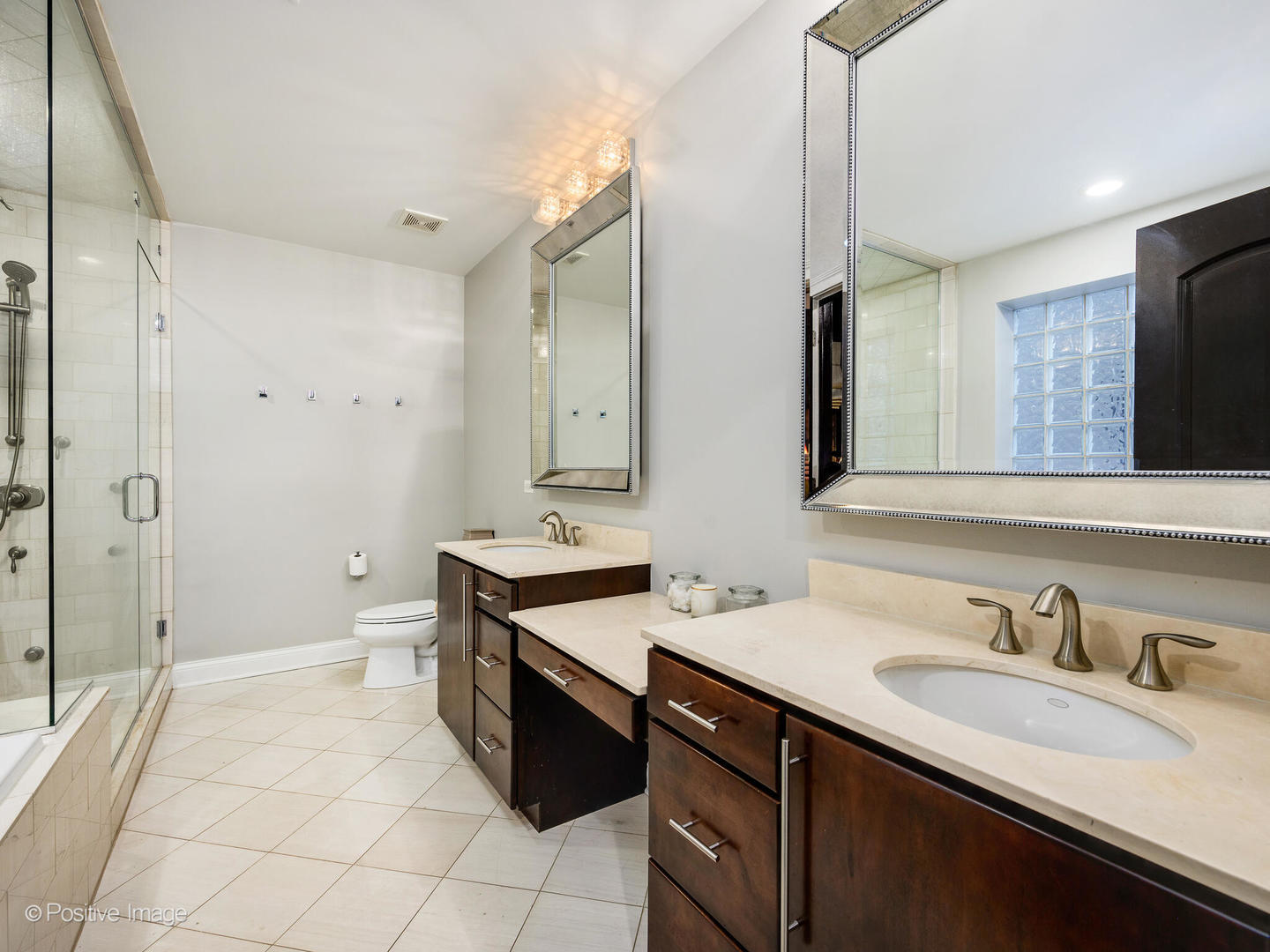 1745 West Roscoe Street, Unit 1 Chicago, IL 60657 - Photo 12 of 29 a spacious bathroom with a double vanity sink mirror double and shower