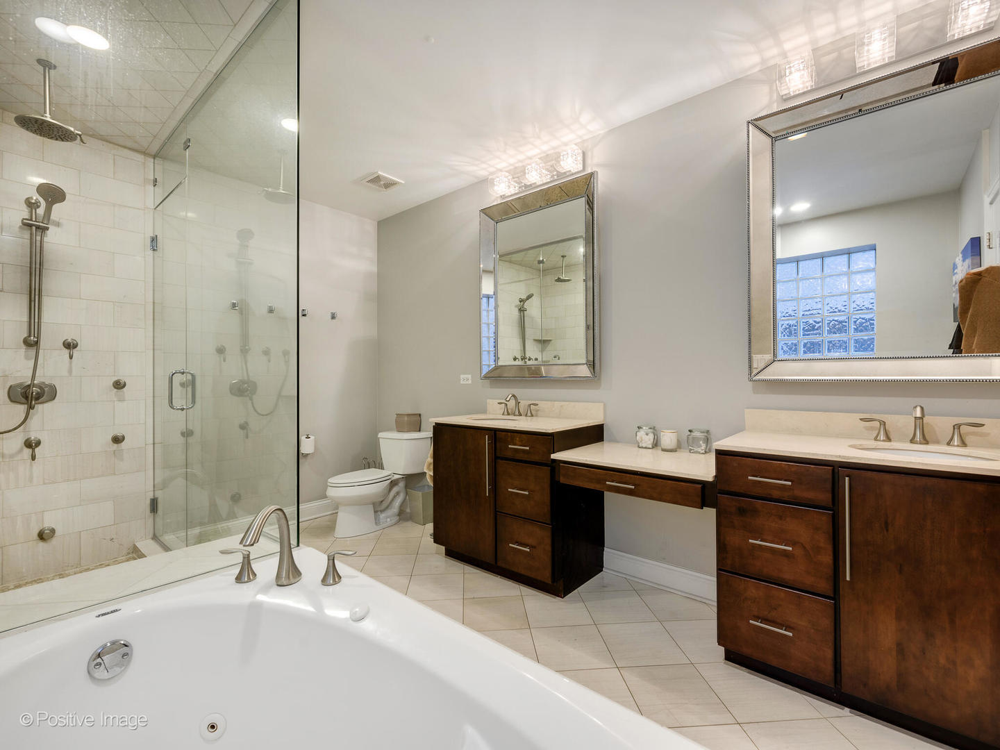 1745 West Roscoe Street, Unit 1 Chicago, IL 60657 - Photo 13 of 29 a bathroom with a sink vanity granite tub shower and a mirror