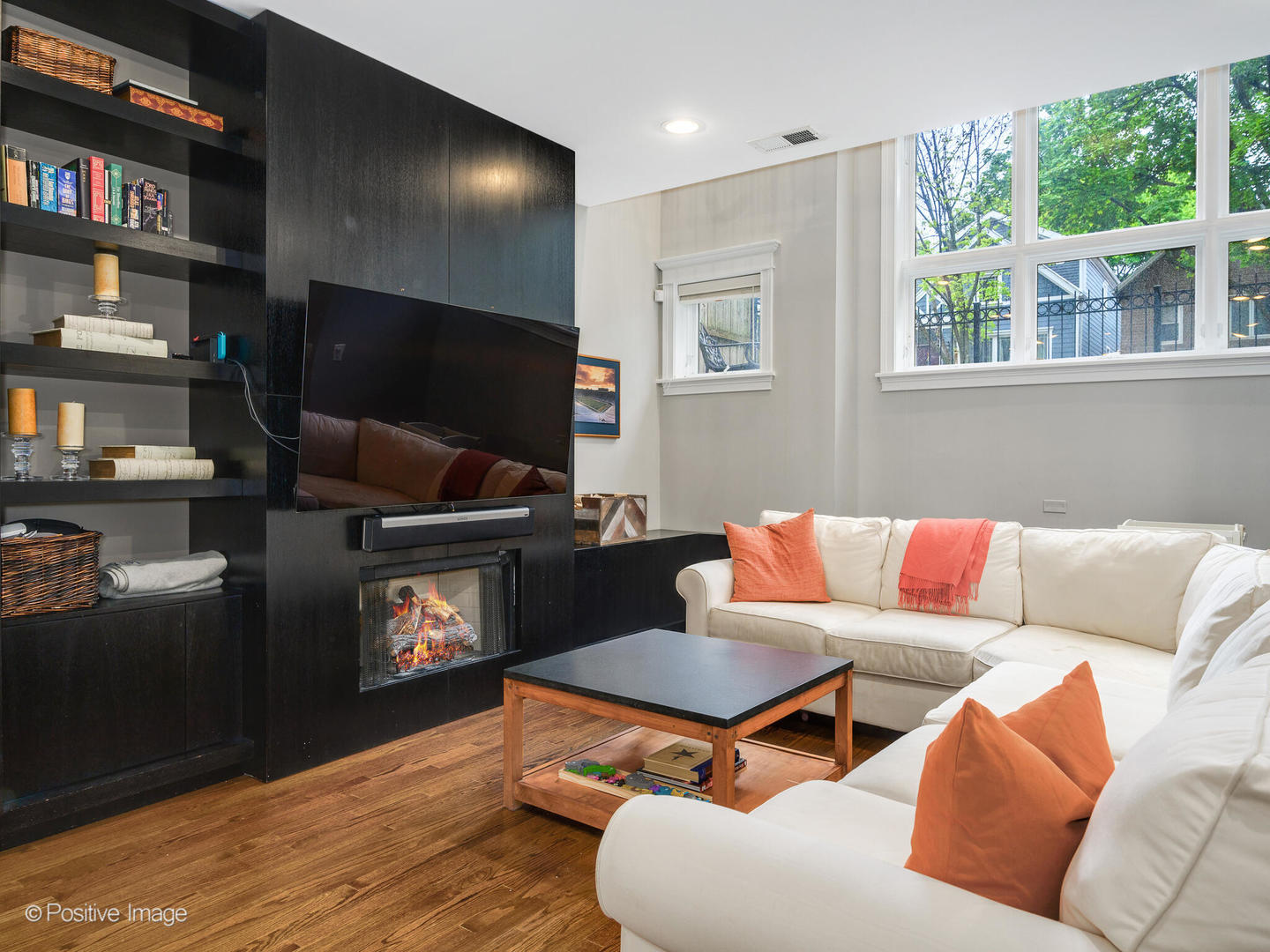 1745 West Roscoe Street, Unit 1 Chicago, IL 60657 - Photo 16 of 29 a living room with furniture a flat screen tv and a fireplace