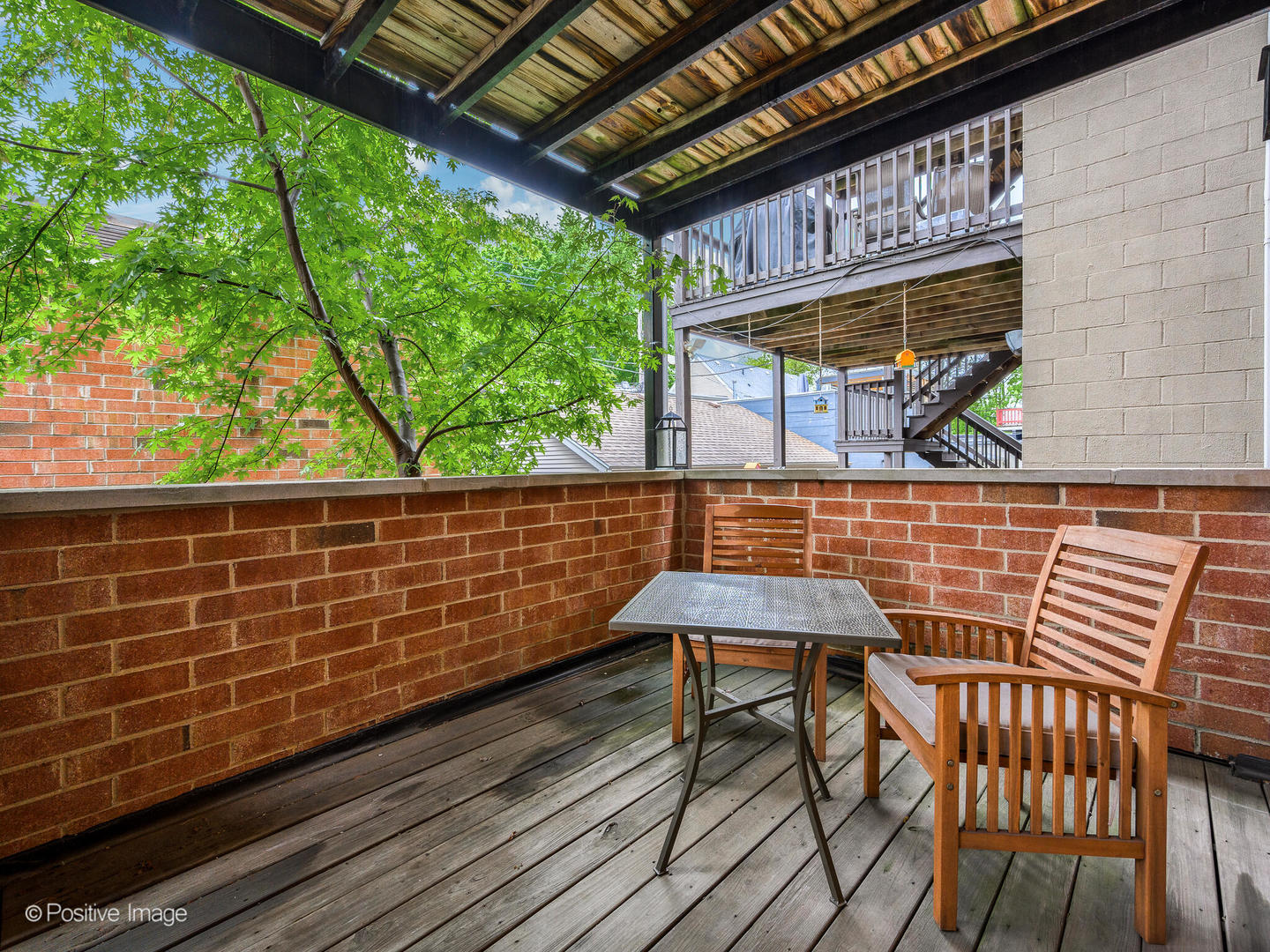 1745 West Roscoe Street, Unit 1 Chicago, IL 60657 - Photo 24 of 29 a balcony with table and chairs