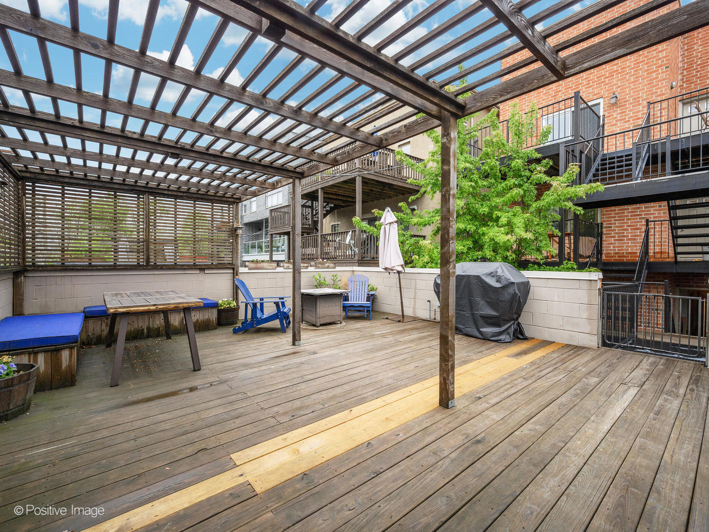 1745 West Roscoe Street, Unit 1 Chicago, IL 60657 - Photo 26 of 29 a living room with furniture and a wooden floor