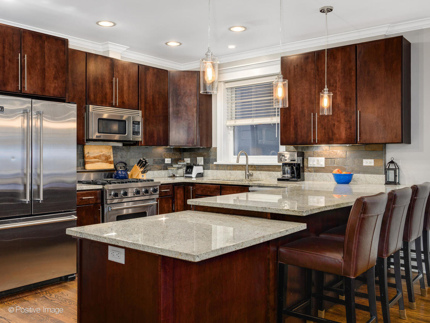 1745 West Roscoe Street, Unit 1 Chicago, IL 60657 - Photo 7 of 29 a kitchen with stainless steel appliances wooden cabinets a stove a sink and a refrigerator