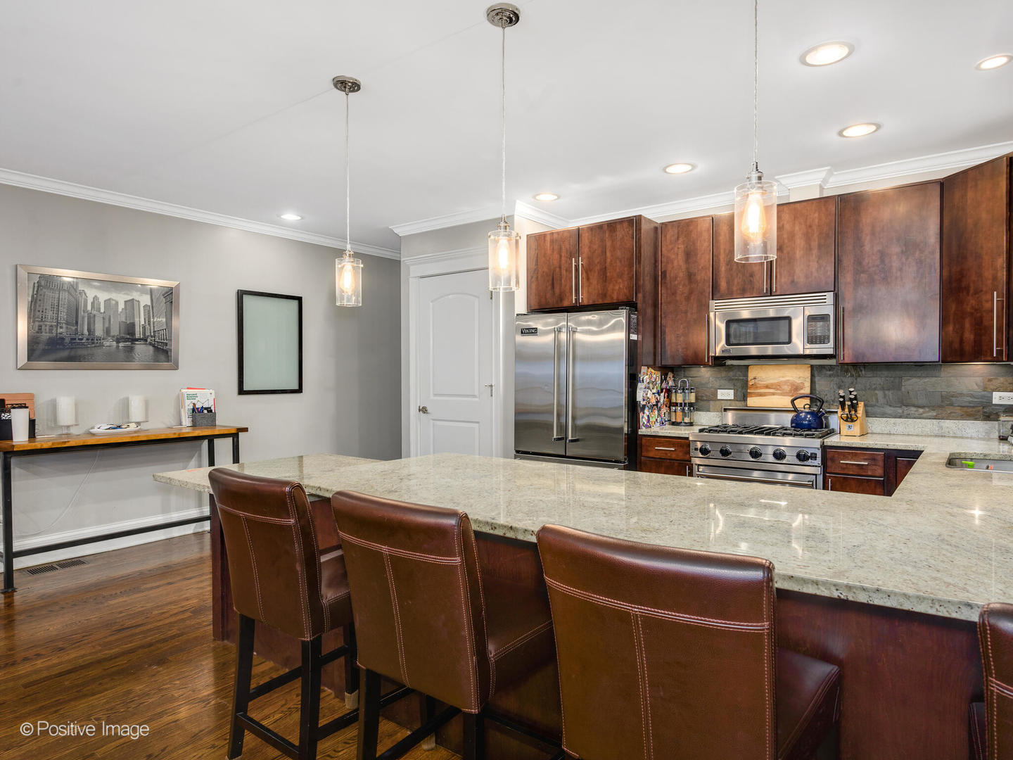 1745 West Roscoe Street, Unit 1 Chicago, IL 60657 - Photo 8 of 29 a kitchen with stainless steel appliances granite countertop a sink refrigerator and microwave
