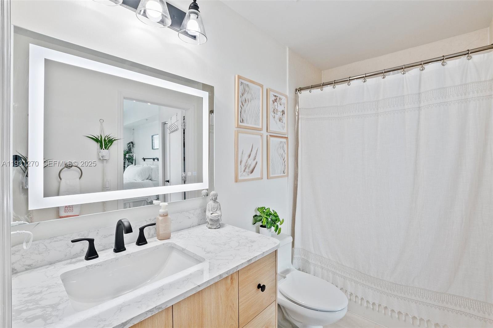 60 Southwest 13th Street, Unit 3603 Miami, FL 33130 - Photo 20 of 27 a bathroom with a granite countertop sink vanity mirror and toilet