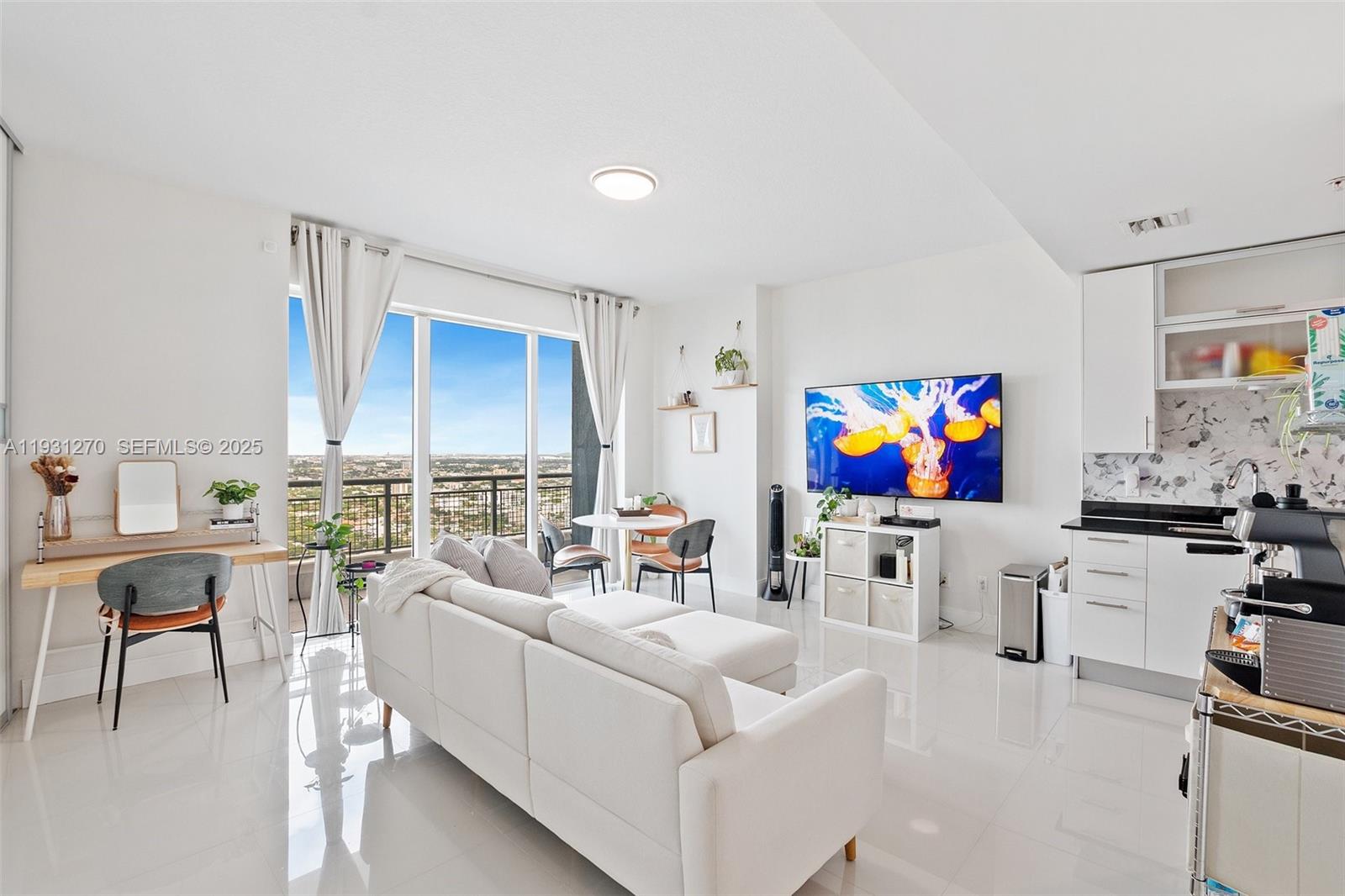 60 Southwest 13th Street, Unit 3603 Miami, FL 33130 - Photo 7 of 27 a living room with furniture a fireplace and a flat screen tv