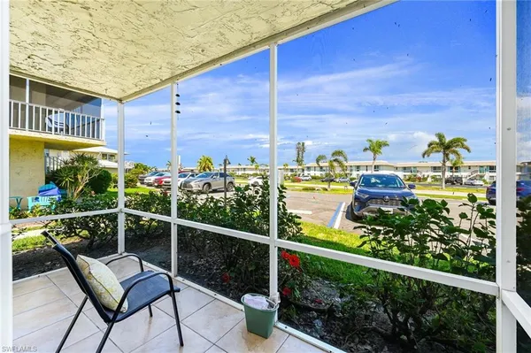 a view of a chairs and table in the balcony