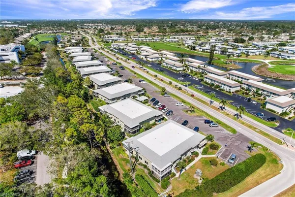 an aerial view of residential houses with outdoor space and river