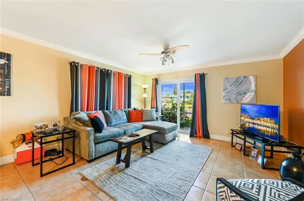 a living room with furniture a rug and a window