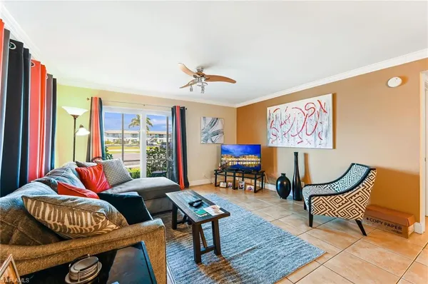 a living room with furniture a rug and a large window