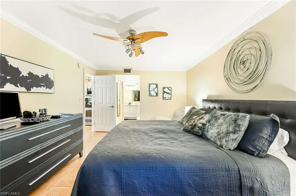 a bedroom with a bed and dresser with mirror