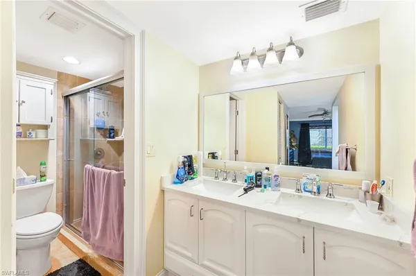 a bathroom with a bathtub sink vanity mirror and toilet