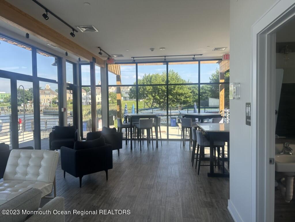 28 Riverside Avenue, Unit 9D Red Bank, NJ 07701 - Photo 3 of 6 a living room with furniture and a floor to ceiling window